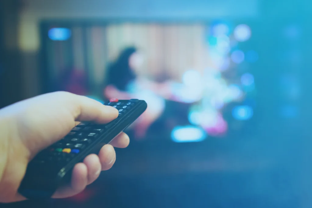 Person Clicking on a TV Remote